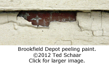 Peeling paint reveals red color on Brookfield depot.